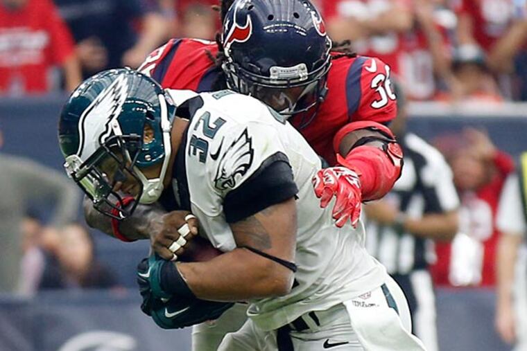 Eagles' Chris Polk runs with the football against Houston Texans' D.J.
Swearinger. (Yong Kim/Staff Photographer)
