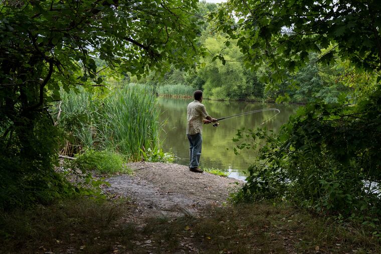 Lacey Poteat, 68, fishes for catfish at Franklin Delano Roosevelt Park at the intersection of Pattison Avenue and Broad Street in South Philadelphia on Tuesday afternoon.