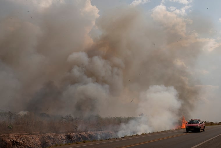 Fire consumes a field along the BR 070 highway near Cuiaba, Mato Grosso state, Brazil, on Sunday, Aug. 25, 2019.