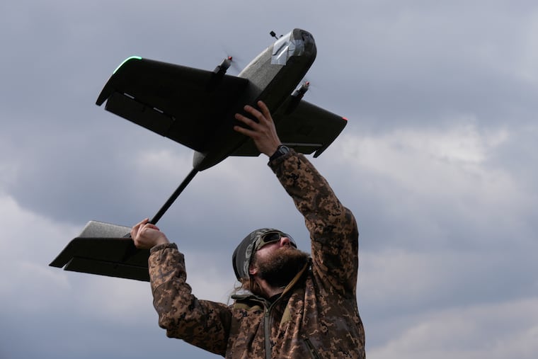 A student soldier of the Yatagan School for Unmanned Aerial Systems launches a training target drone during drills in the Kyiv region, Ukraine, Thursday, March 19, 2026.