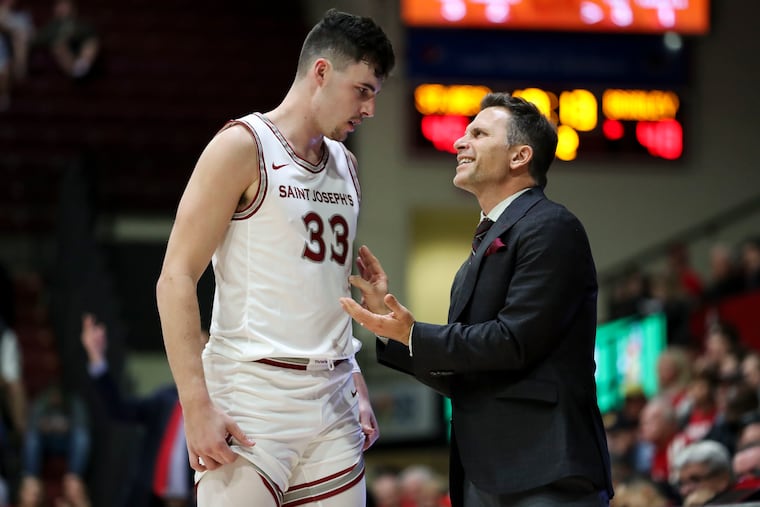 Taylor Funk talks with head coach Billy Lange in a November game.