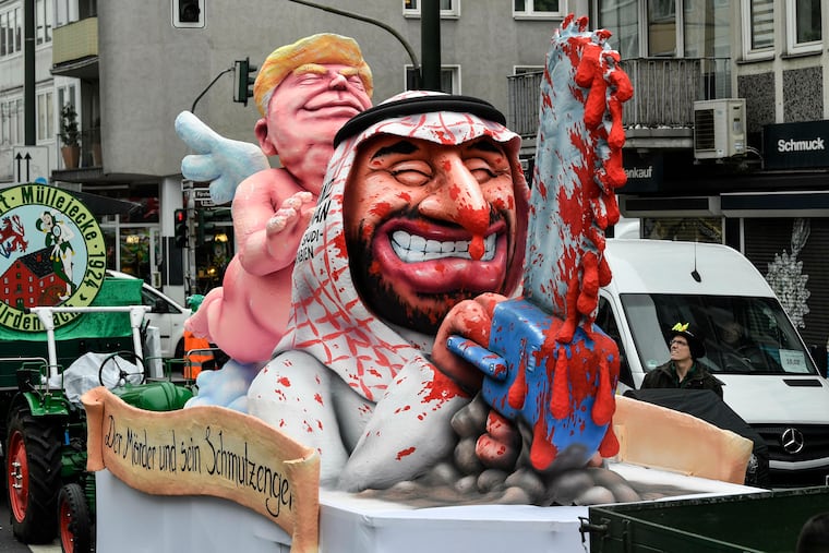 A carnival float depicts President Donald Trump as an angel of peace behind Saudi Crown Prince Mohammed bin Salman with a bloody chain saw prior to the traditional carnival parade in Duesseldorf, Germany, on Monday, March 4, 2019. The foolish street spectacles in the carnival centers of Duesseldorf, Mainz and Cologne, watched by hundreds of thousands of people, are the highlights in Germany's carnival season on Rosemonday. (AP Photo/Martin Meissner)