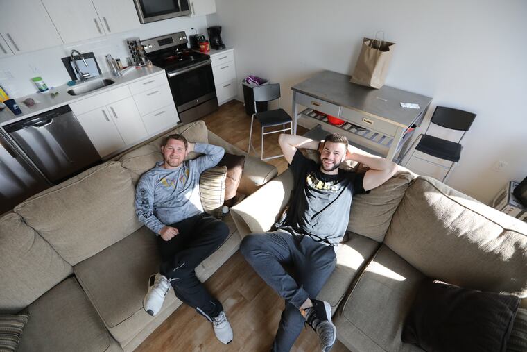 Wings players Matt Rambo (left) and Anthony Joaquim live together in an apartment in Center City that the team provides as long as the players work at other jobs.
