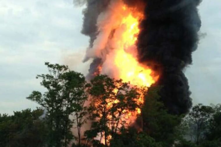 Flames and smoke erupted after a freight train hit a trash truck and derailed in Rosedale, Md. (Courtesy of Kevin Lindemann / AP)