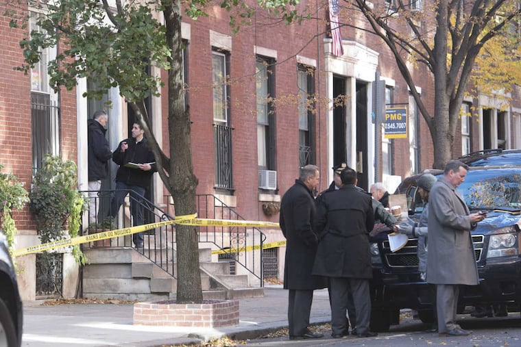 Investigators gather on the 1800 block of Pine Street, where a man was injured at 4 a.m. Tuesday opening a package that exploded.