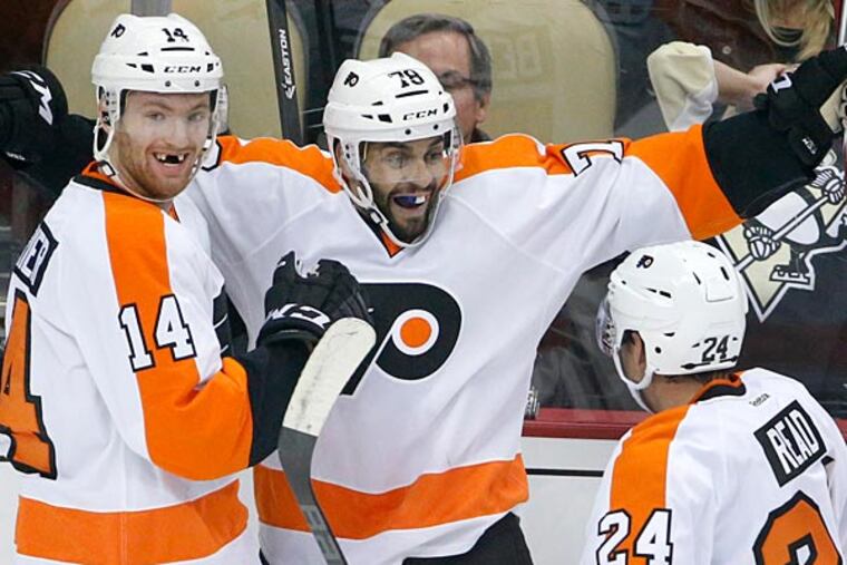Philadelphia Flyers' Pierre-Edouard Bellemare (78) celebrates his goal with Sean Couturier (14), and Matt Read (24) in the first period of an NHL hockey game against the Pittsburgh Penguins in Pittsburgh, Wednesday, Oct. 22, 2014. (Gene J. Puskar/AP)