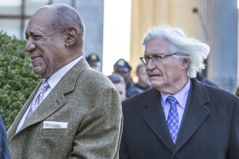 Bill Cosby leaves the Montgomery County Courthouse, followed by his attorney Thomas Mesereau after a pre-trial hearing for his second trial on sexual assault.