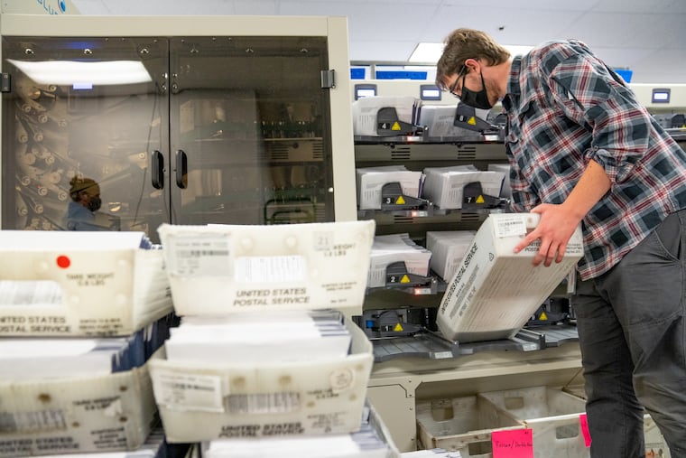 A worker organizes mail ballots in Chester County. Pennsylvania counties have been flooded with mail ballot requests, and the days-long process of counting them can’t begin until Election Day under current state law.