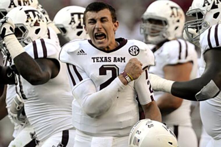 Texas A&M quarterback Johnny Manziel (2) celebrates after a review
proves an Aggie touchdown during the first half of their first SEC
meeting against and Alabama in an NCAA college football game,
Saturday, Nov. 10, 2012, in Tuscaloosa, Ala. No. 15 Texas A&M defeated
No. 1 Alabama 29-24. (AP Photo/The Decatur Daily, Gary Cosby Jr.)