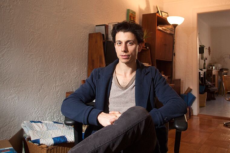 Josh Fattal, in his Brooklyn apartment last week, reflects about his ordeal as one of three American hikers imprisoned in Iran. They have co-authored a memoir and will speak at the Free Library. ED HILLE / Staff Photographer