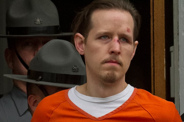 Eric Frein, charged with murder of Pennsylvania State Trooper Cpl. Byron Dickson and critically wounding Trooper Alex Douglass Sept. 10, is taken to prison after a preliminary hearing in Pike County Courthouse on Friday, Oct. 31, 2014 in Milford, Pa.