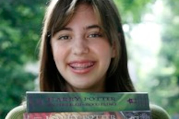 Susanne Collins, 15, of Hatboro with her books. No. 7 will be "sad because it's going to be the end."