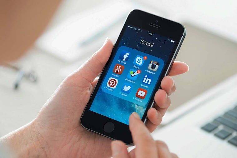 User looking on social media applications on an Apple iPhone 5S.