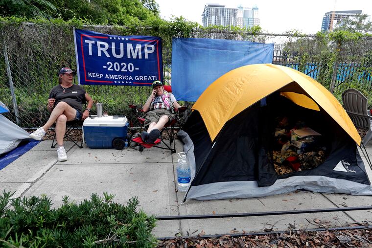 Anna Connelly, left, and Jeanna Gullett supporters of President Donald Trump, make camp Monday, June 17, 2019, in Orlando, Fla., as they wait to attend a rally for the president on Tuesday evening.