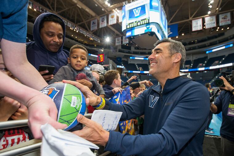 Coach Jay Wright, right, of Villanova signs autographs for a group of youths following their practice. Villanova ran through their public practice session at the XL Center in Hartford, CT on March 20, 2019 as they prepare for their game against St. Mary’s in the NCAA Tournament.