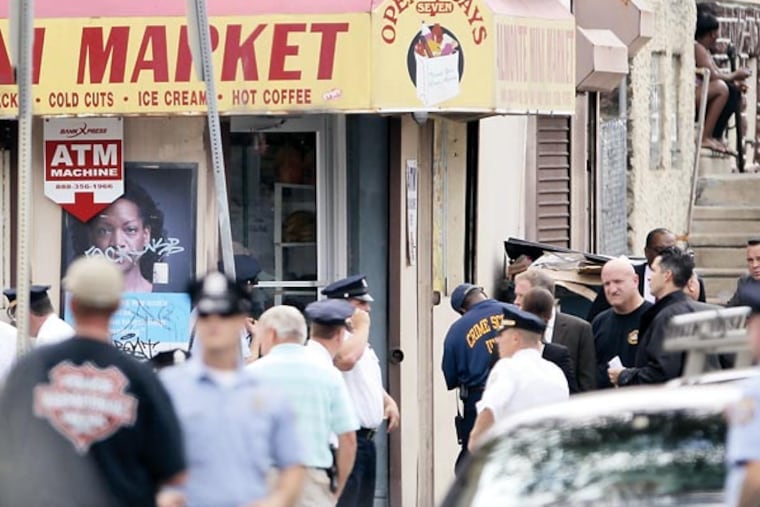 Police investigate the scene at 4th and Annbury streets in Philadelphia on August 13, 2013. A Philadelphia police officer was shot at the scene. (DAVID MAIALETTI / Staff Photographe )
