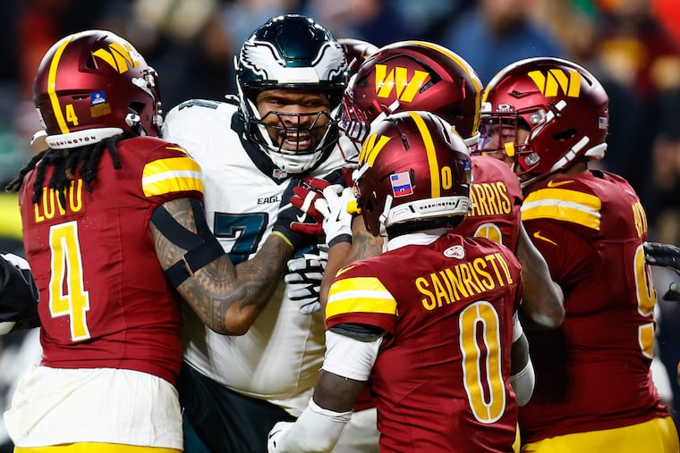 Eagles offensive tackle Fred Johnson gets in a shoving match with Commanders players during the fourth quarter Saturday. Steen ultimately was among three players ejected.