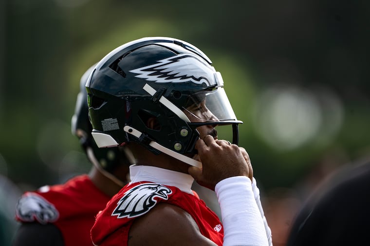 Eagles quarterback Jalen Hurts adjusts his helmet as he prepares to begin practice at the NovaCare Complex earlier this week.