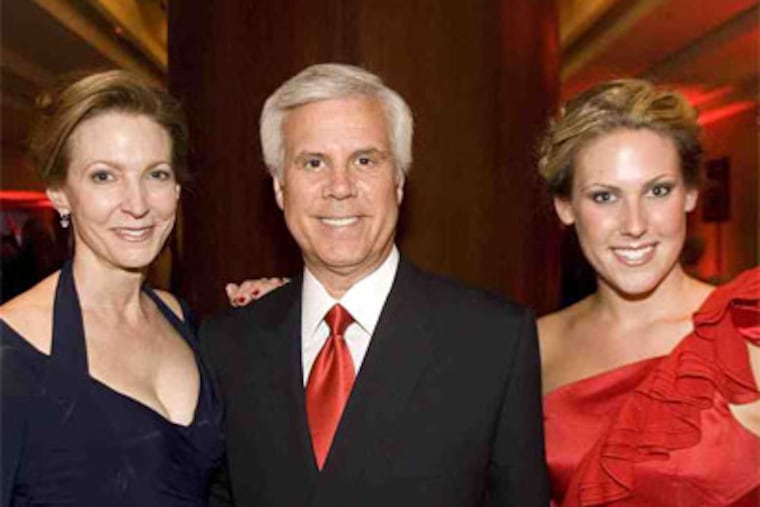 George E. Norcross III, board chair of Cooper University Hospital, with wife, Sandy (left), and daughter Lexie at the Cooper Red Hot Gala at the Hyatt Regency. (Photo / Jason Rearick)