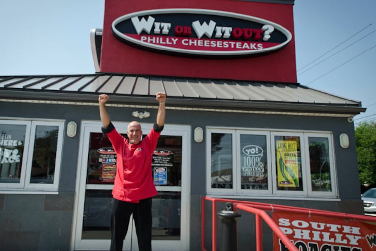 Tony Altomare, owner and operator of “Wit or Witout? cheesesteak shops, strikes the Rocky pose outside his shop at 9970 Roosevelt Blvd. (RON TARVER/Staff Photographer)