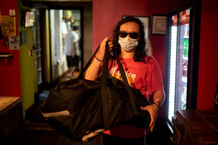Rustica driver Josiah Schlatter, 30, of West Philadelphia, heads out for a delivery in Northern Liberties. Schlatter has been working at Rustica for three years and works fewer hours than usual due to the coronavirus pandemic.