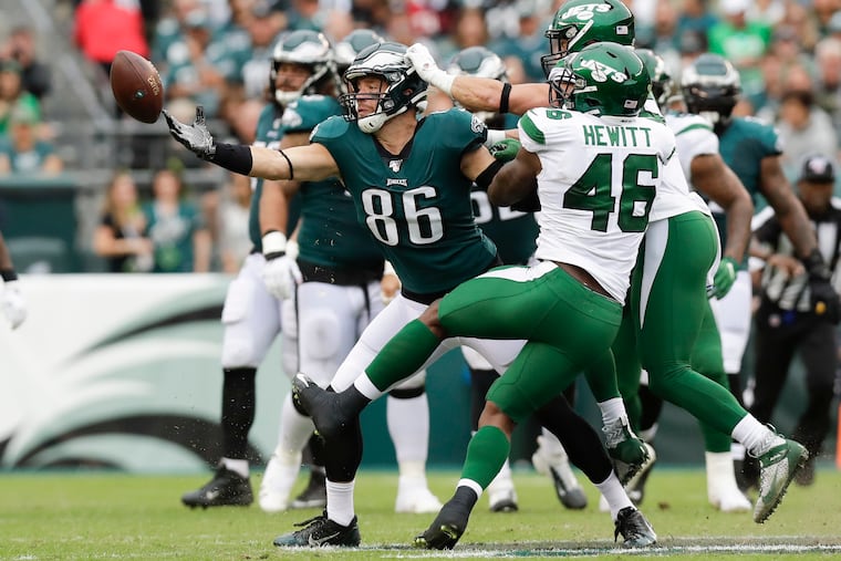 Eagles tight end Zach Ertz reaches for the ball against New York Jets linebacker Neville Hewitt in the second quarter on Sunday, October 6, 2019 in Philadelphia.