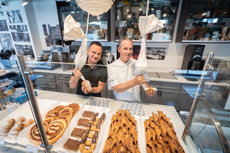Vincent Termini Jr. (left) fills a lobster tail pastry while brother Joseph Termini fills a cannoli at their new dessert shop, Nonna & Pop's. It opened in honor of their parents, Vincent Sr. and Barbara, who own Termini Bros. Bakery across the street.