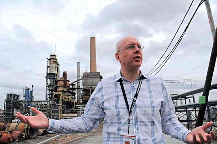 Jonathan Hunt, director of operations of Sunoco's Marcus Hook Industrial Complex, talks April 14, 2014 about his company's plan to demolish Sunoco old petroleum refinery's into one that handles Marcellus Shale natural gas liquids. Sunoco Logistics is building new above-ground storage equipment for the Marcellus Shale propane and ethane. In the background is the old Fluid Catalytic Cracking Unit, which is being demolished. ( CLEM MURRAY / Staff Photographer )