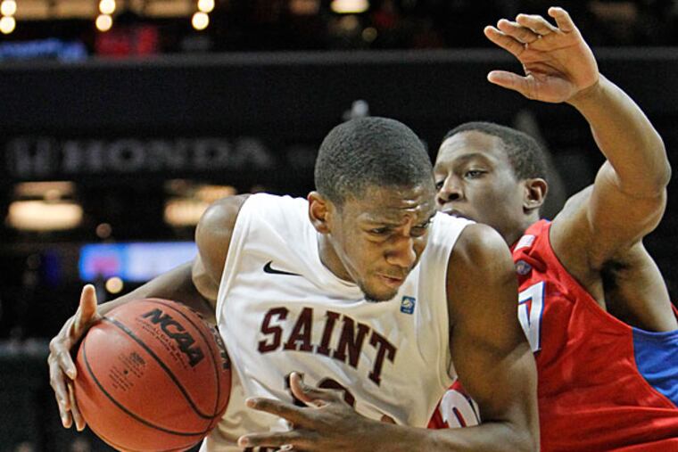 St. Joe's Langston Galloway tries to drive despite pressure from Dayton's Jordan Sibert. (Ron Cortes/Staff Photographer)