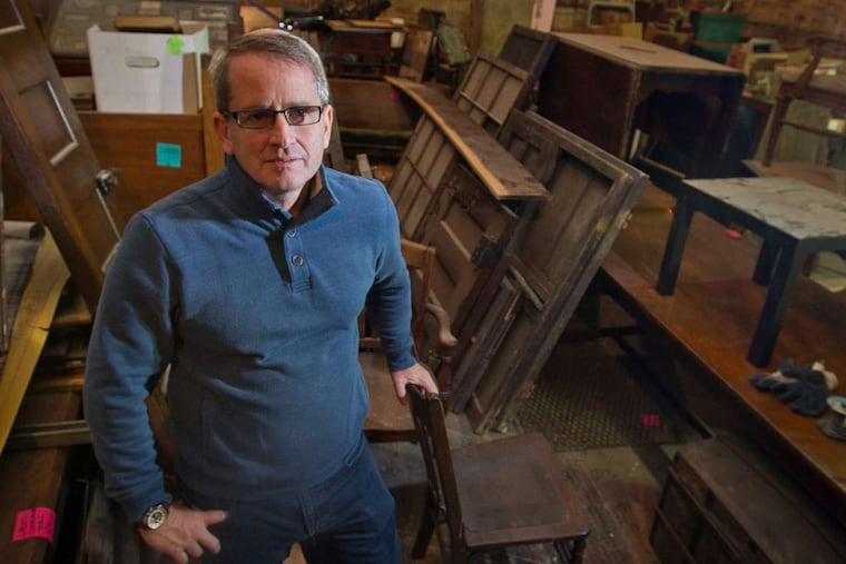 The Rev. Mike Harder stands among furniture stored in the gym during renovations. The gym will become a center to aid the homeless.