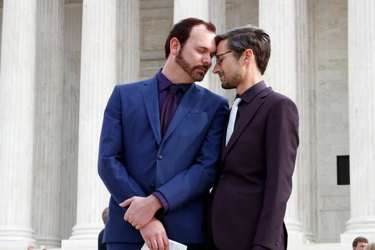 In this Dec. 5, 2017 file photo, Charlie Craig, left, and David Mullins touch foreheads after leaving the Supreme Court in Washington.