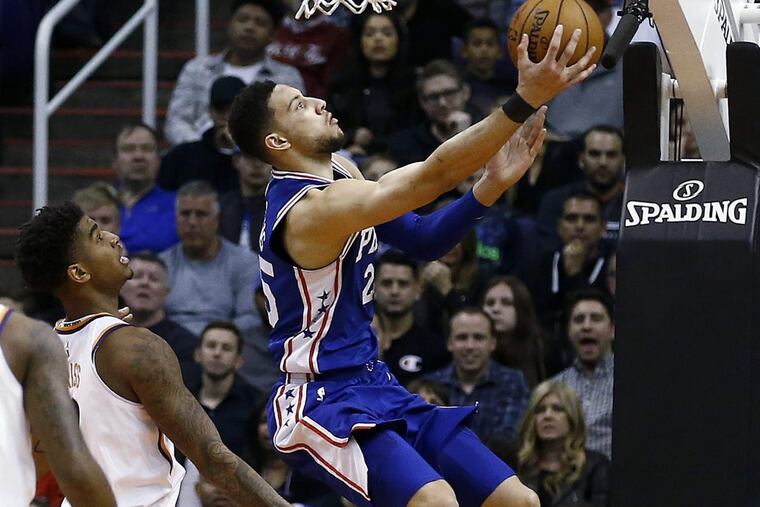 Sixers’ guard Ben Simmons, right, shoots as he gets past Phoenix Suns forward Marquese Chriss, left, during the team’s win over Phoenix on Sunday.