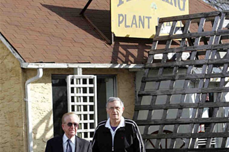 Broker Joseph Ridolfi (left) and property owner Bill Varanyak walk along the Tree King tract in Hamilton Township, near Trenton. The zoning has hampered efforts to sell the plot. (Martin Griff / Trenton Times)