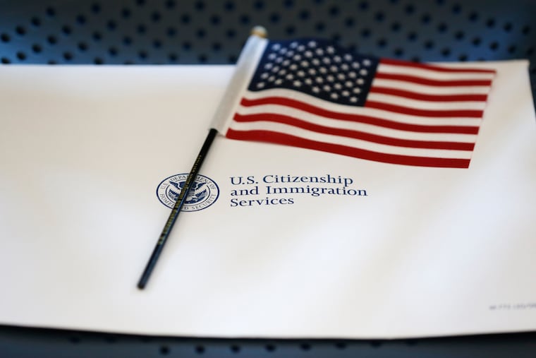 An information packet and an American flag are placed on a chair at the U.S. Citizenship and Immigration Services Miami Field Office in 2018.