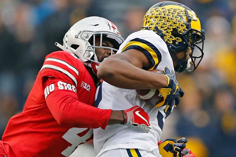 Ohio State safety Jordan Fuller (4) tackles Michigan wide receiver Donovan Peoples-Jones.