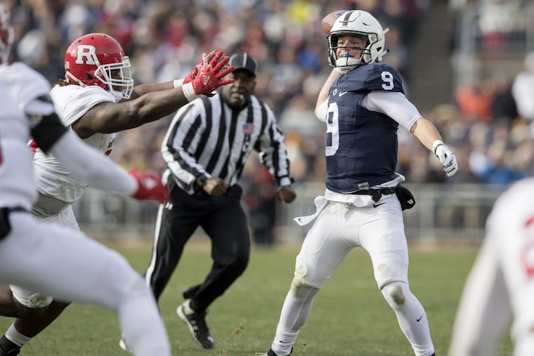 Penn State quarterback Trace McSorley attempts a pass as he is pressured by Rutgers defenders.