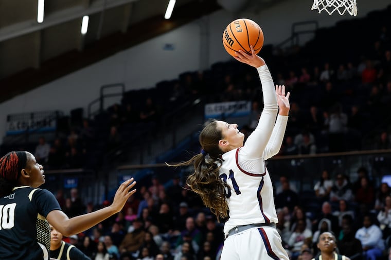 Cardinal O’Hara's Megan Rullo (right) drives to the basket against Neumann Goretti on Monday.