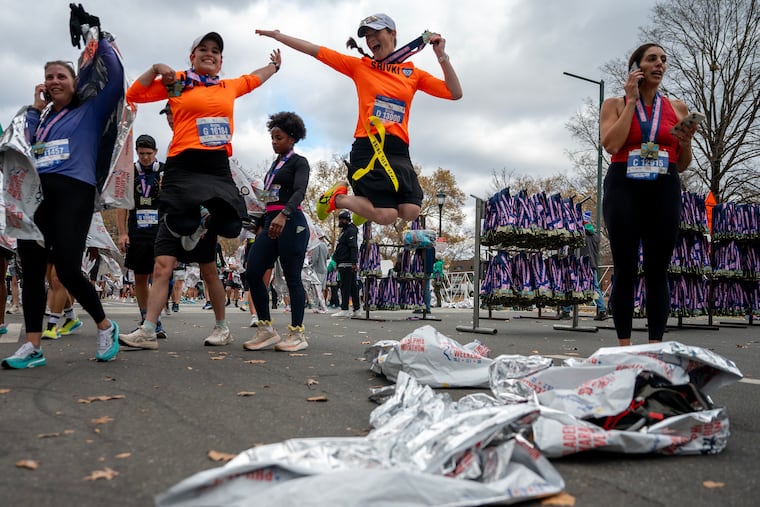Naomi Peker (left) and Srivki Weisberg (right) jump to celebrate their finish in the 2024 Philadelphia Marathon Sunday, Nov. 24, 2024. They run together with a club in Suffern, NY, and this was Peker’s first marathon.