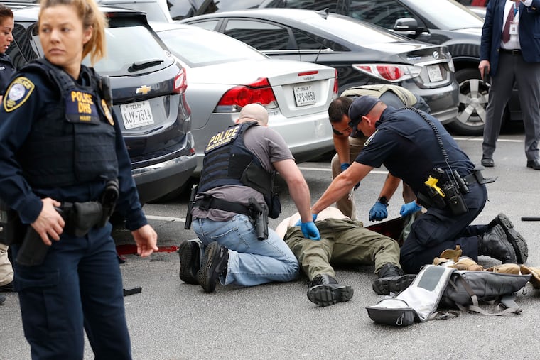 Law enforcement officers with the alleged gunman hovers in the parking lot of the Earle Cabell federal courthouse in downtown Dallas on Monday, June 17, 2019. (Tom Fox / Dallas Morning News)