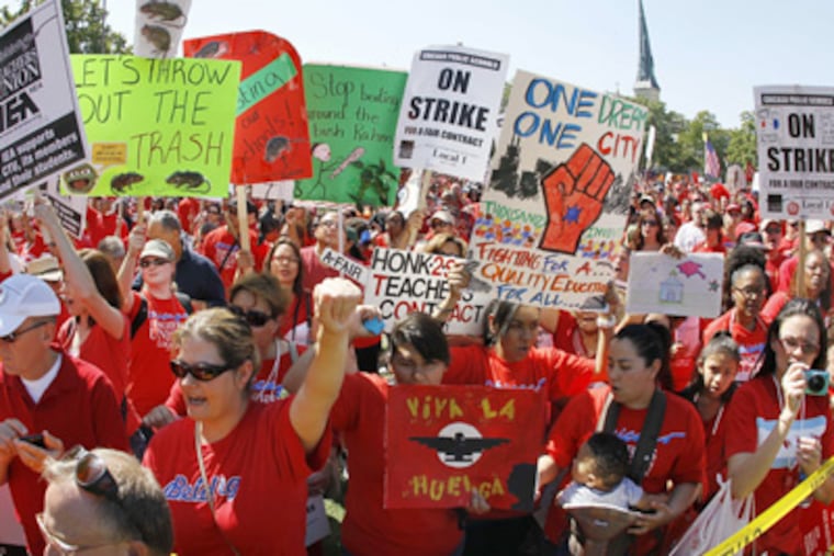Striking Chicago school teachers rally at Union Park Saturday, Sept.; 15, 2012, in Chicago. Union president Karen Lewis reminded the crowd; that although there is a "framework" for an end to their strike, they; still are on strike.(AP Photo/Charles Rex Arbogast)