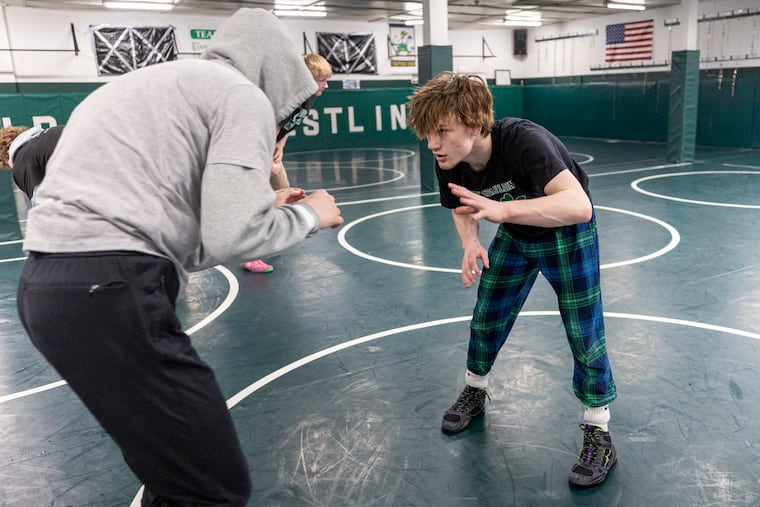 Sammy Spaulding, 17, of Runnemede (right) practices with Michael Craft, 17, of West Hampton on Wednesday at Camden Catholic.