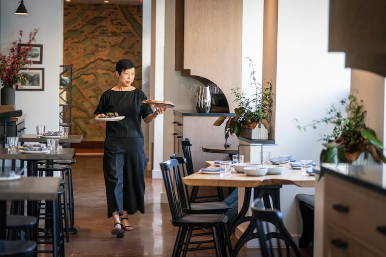 Restaurateur Ellen Yin walks through the dining room at High Street, which moved from Old City to East Market in 2023 and is credited with revitalizing the historic Franklin Residences.