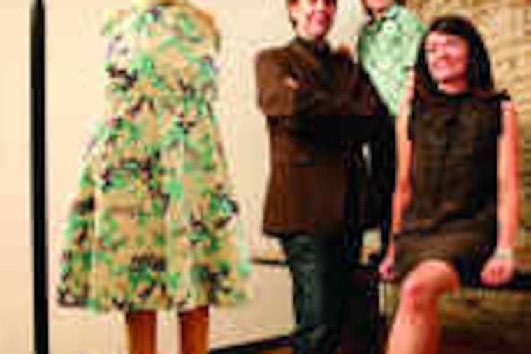 Martin Duffy, his wife, Christine Johnston, and their son, Calder, with one of Johnston's new designs for girls, which she calls Aqua Poppies.