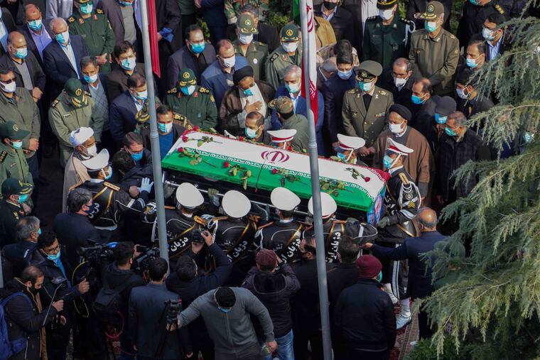 In this photo released by the official website of the Iranian Defense Ministry, military personnel carry the flag draped coffin of Mohsen Fakhrizadeh, a scientist who was killed on Friday, in a funeral ceremony in Tehran, Iran.