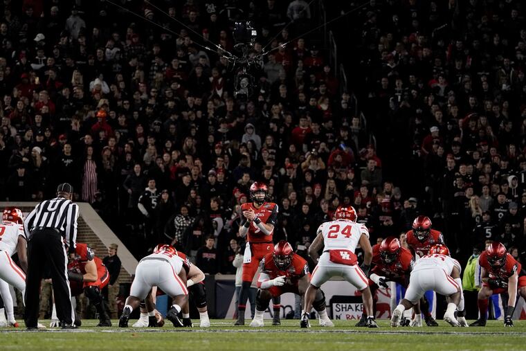 Cincinnati quarterback Desmond Ridder prepares to take the snap during the second half of an American Athletic Conference championship NCAA college football game against Houston on Dec. 4, 2021, in Cincinnati. The American Athletic Conference announced an agreement, Friday, June 10, 2022, with Cincinnati, Houston and UCF that paves the way for the schools to join the Big 12 in 2023.
