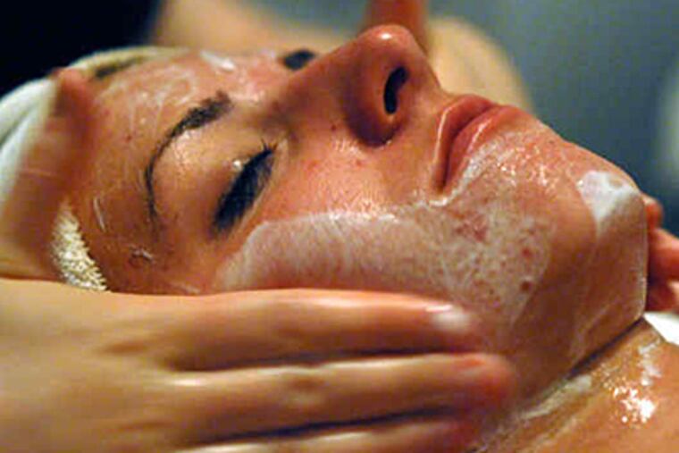 Rachel Wenk, getting a facial at Bernard's, paid less than half price, thanks to Groupon. (April Saul/Staff)