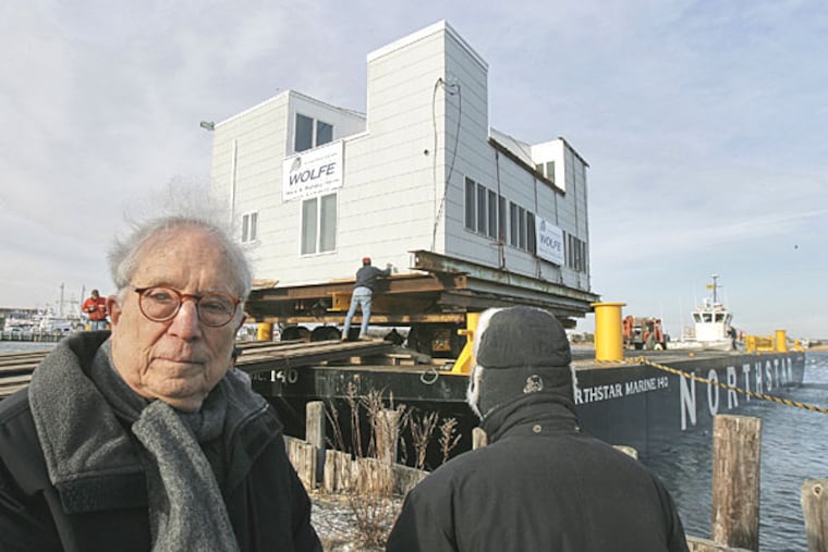 Architects Robert Venturi, left, and Denise Scott Brown look on this morning as the Lieb House, which they designed in the 1960s, is loaded onto a barge for its move from Barnegat Light, N.J., to its new home on the North Shore of Long Island.
