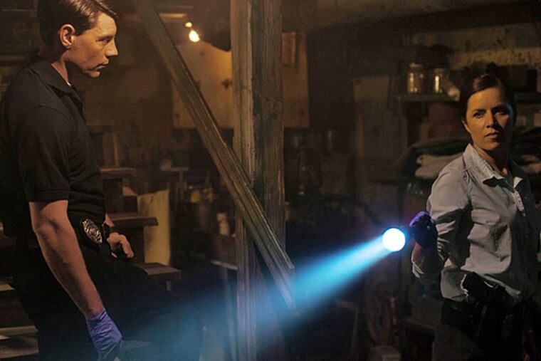 Patrick Fugit, left, and Kim Dickens appear in a scene from "Gone Girl." The film, based on the best-selling novel, will release on Oct. 3. (AP Photo/20th Century Fox, Merrick Morton)