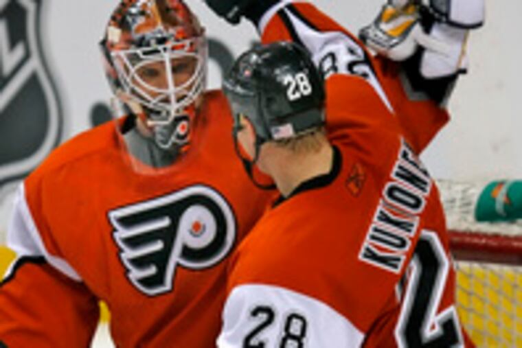 Flyers goalie Martin Biron is congratulated by Lasse Kukkonen after yesterday's win.