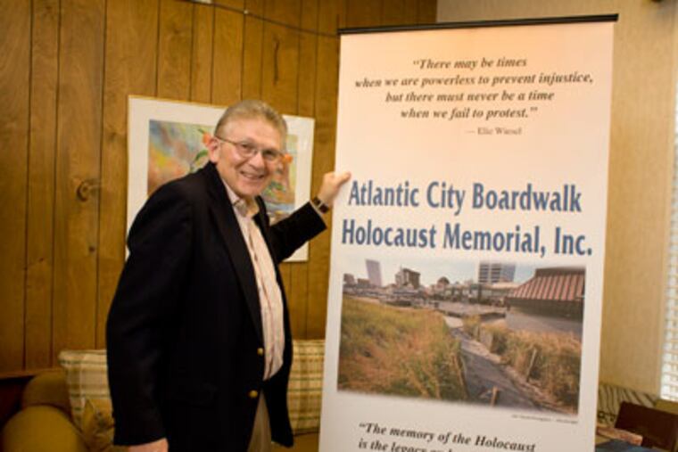 Rabbi Gordon Geller, president of the Atlantic City Boardwalk Holocaust Memorial, with a banner made by a member of his congregation at Temple Emeth Shalom in Margate. ( Ed Hille / Staff Photographer )